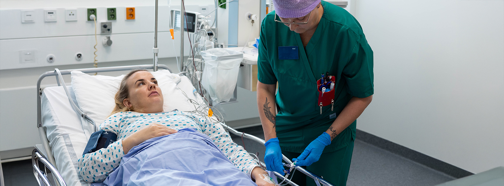 Sairaanhoitaja valmistelee potilasta punasolujen siirtoon.